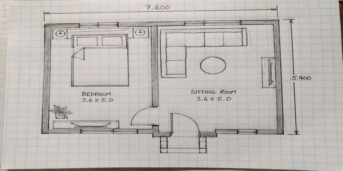 Simple hand-drawn floor plan sketch on graph paper showing bedroom and sitting room layout